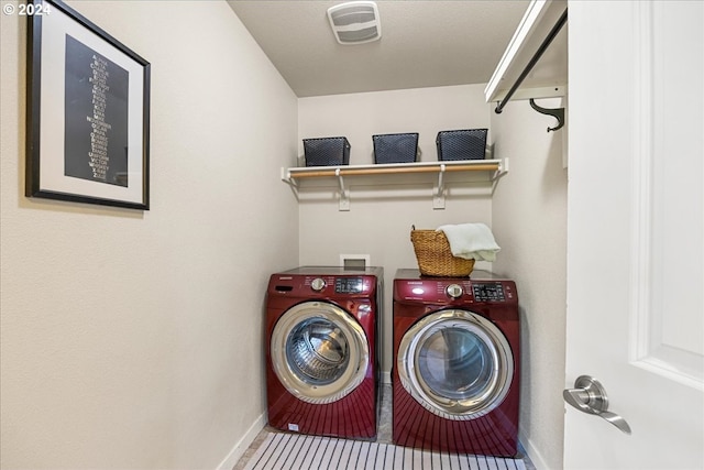 washroom featuring tile patterned flooring and washer and clothes dryer