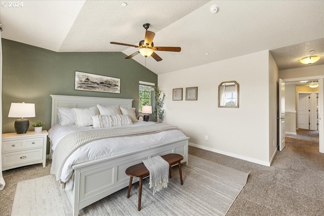 bedroom featuring ceiling fan, lofted ceiling, light carpet, and a textured ceiling