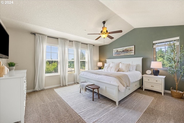 bedroom featuring lofted ceiling, ceiling fan, light colored carpet, and a textured ceiling