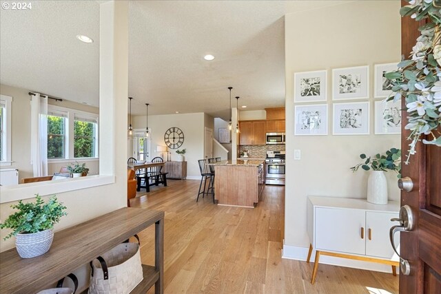 interior space with a textured ceiling and light wood-type flooring