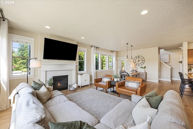 living room with light hardwood / wood-style flooring and a textured ceiling