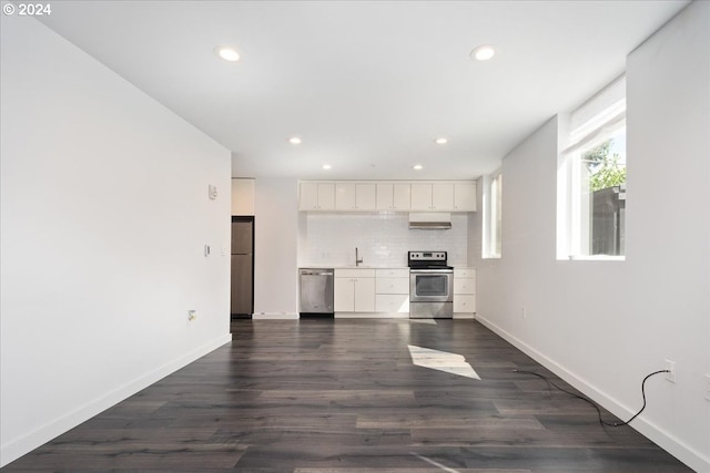 kitchen with stainless steel appliances, white cabinets, sink, dark hardwood / wood-style floors, and backsplash