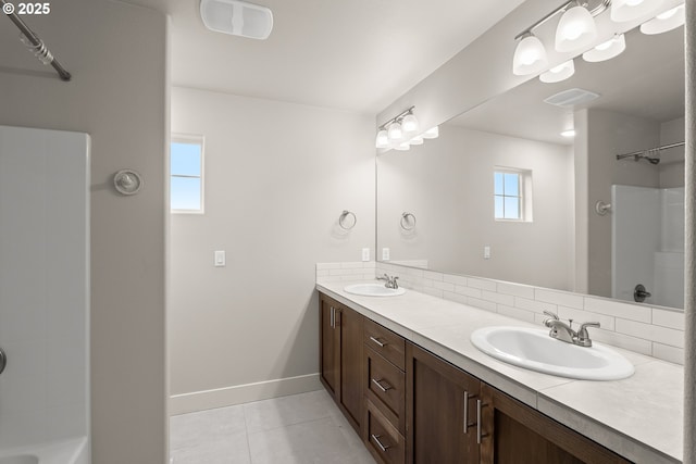 bathroom featuring vanity, a wealth of natural light, and walk in shower