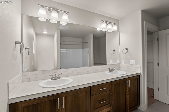 bathroom with tasteful backsplash and vanity