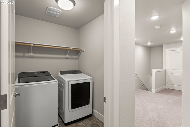 laundry room featuring dark colored carpet and separate washer and dryer