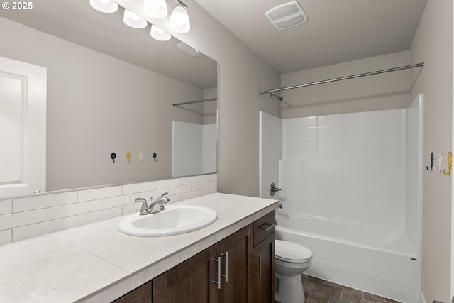 full bathroom featuring bathing tub / shower combination, vanity, backsplash, and toilet