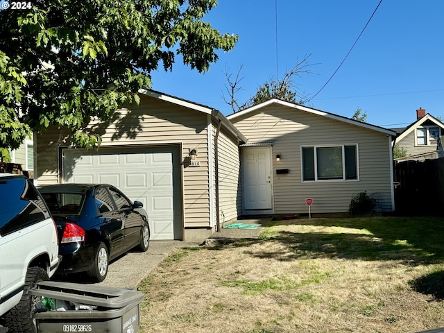 ranch-style home with a front lawn and a garage