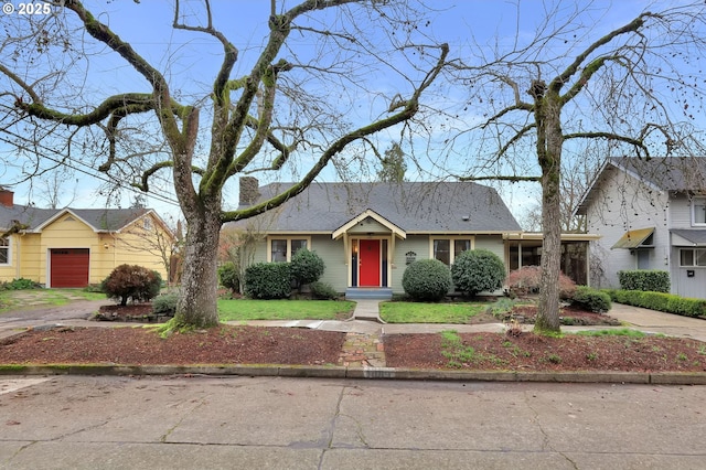 ranch-style home with a front lawn and a garage