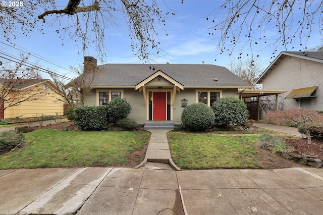 bungalow-style house featuring a front lawn and a carport