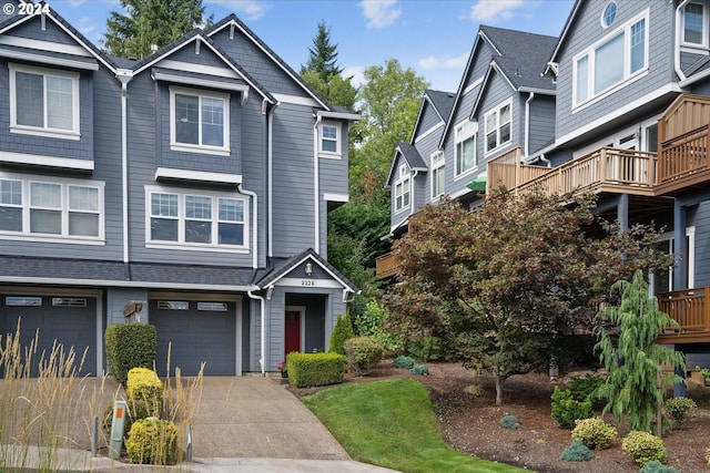 view of front of house featuring a garage, driveway, and a shingled roof