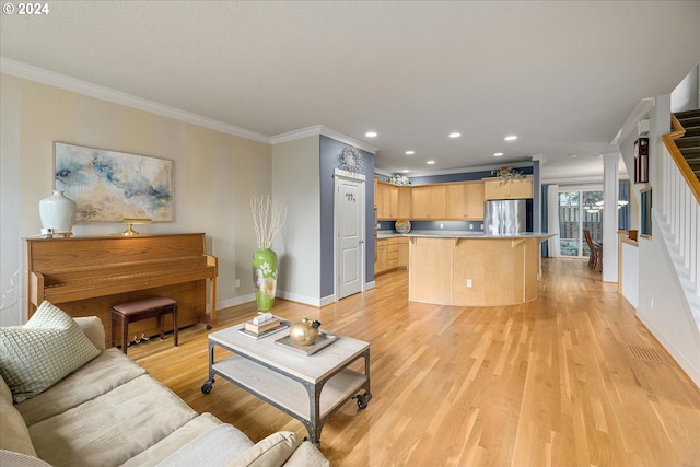 living room with ornamental molding and light hardwood / wood-style floors