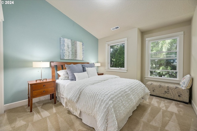 bedroom with light carpet, multiple windows, lofted ceiling, and visible vents