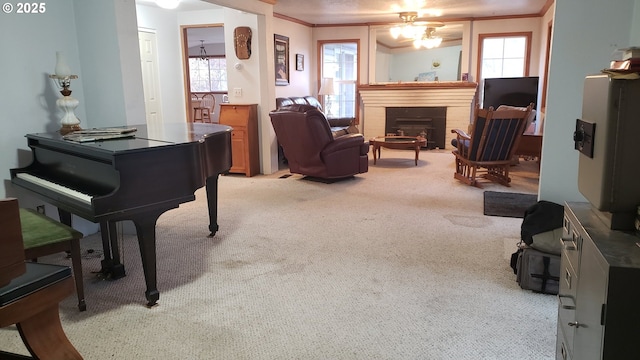 carpeted living room with ceiling fan and crown molding