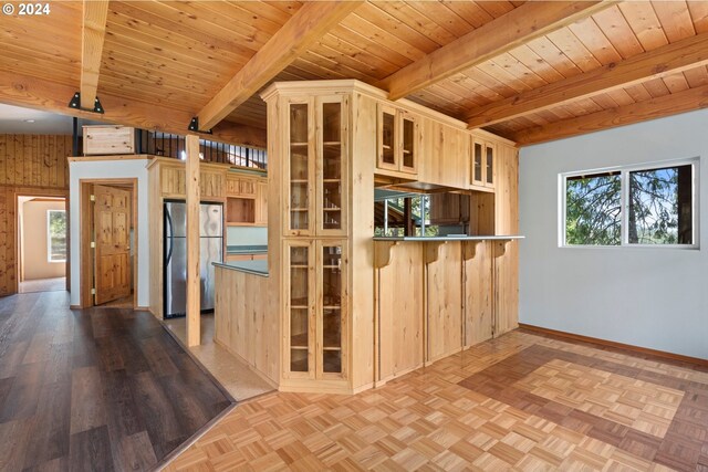 kitchen with wooden walls, wood ceiling, stainless steel refrigerator, light parquet flooring, and beam ceiling