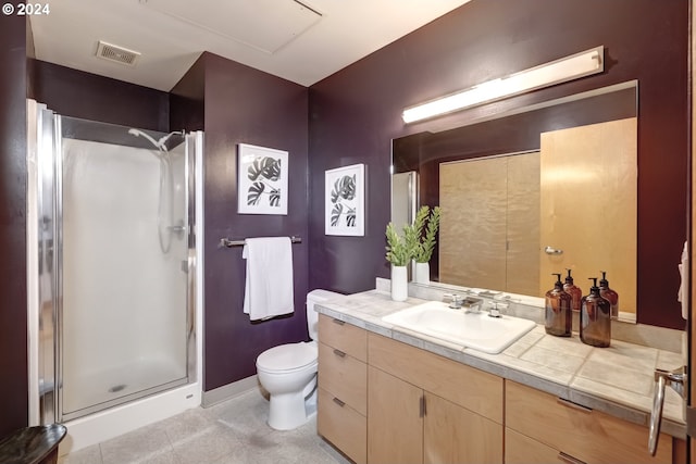 bathroom with tile patterned flooring, vanity, toilet, and an enclosed shower