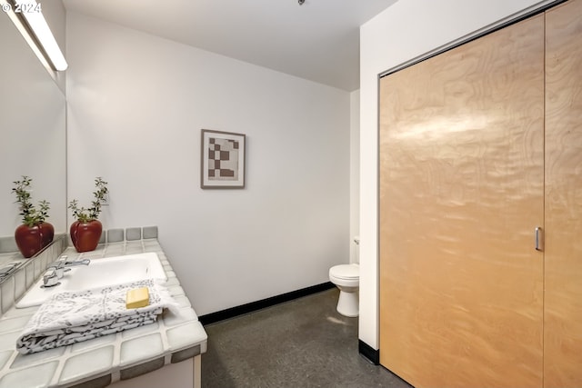 bathroom featuring vanity and toilet