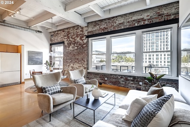 interior space with rail lighting, wood-type flooring, wooden ceiling, and brick wall