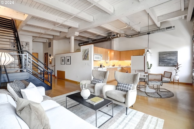 living room featuring light hardwood / wood-style flooring and beam ceiling