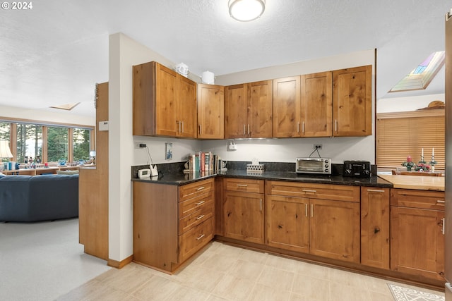 kitchen featuring dark stone countertops and a textured ceiling