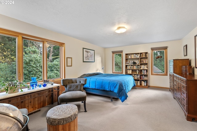 carpeted bedroom featuring a textured ceiling