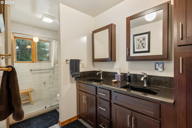 bathroom with vanity, toilet, and an enclosed shower