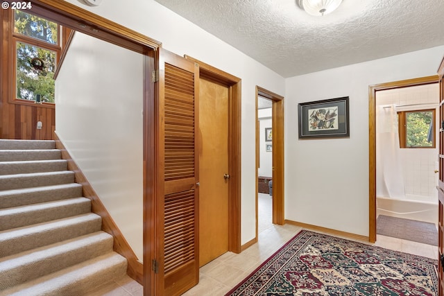 hallway featuring a textured ceiling