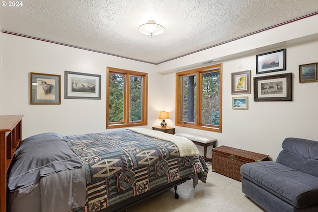 bedroom featuring light carpet and a textured ceiling