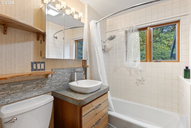 full bathroom featuring shower / tub combo, backsplash, tile walls, vanity, and toilet