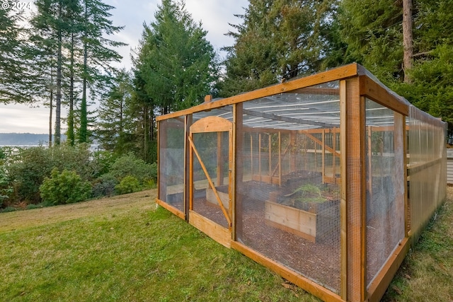 view of outdoor structure featuring a lawn