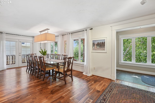 dining area featuring plenty of natural light, dark hardwood / wood-style flooring, and french doors