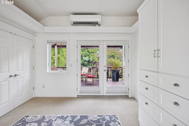 unfurnished bedroom featuring lofted ceiling, light carpet, access to outside, french doors, and an AC wall unit