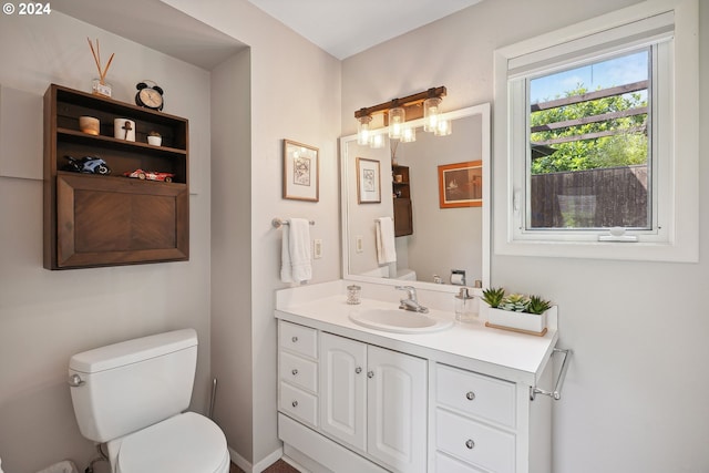 bathroom featuring vanity and toilet