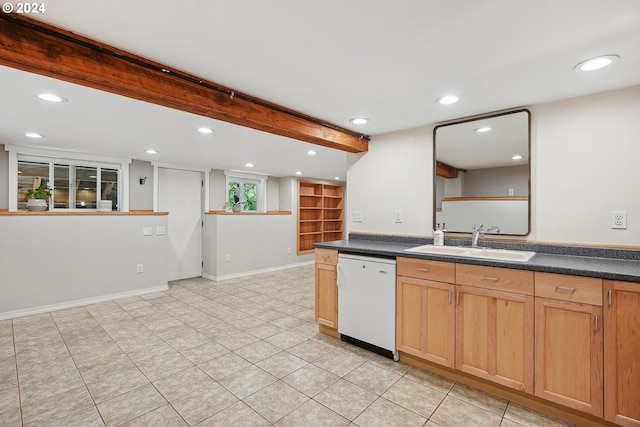 kitchen featuring white dishwasher, light tile patterned floors, and sink