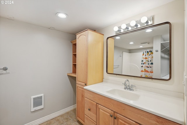 bathroom with vanity, a shower, and heating unit