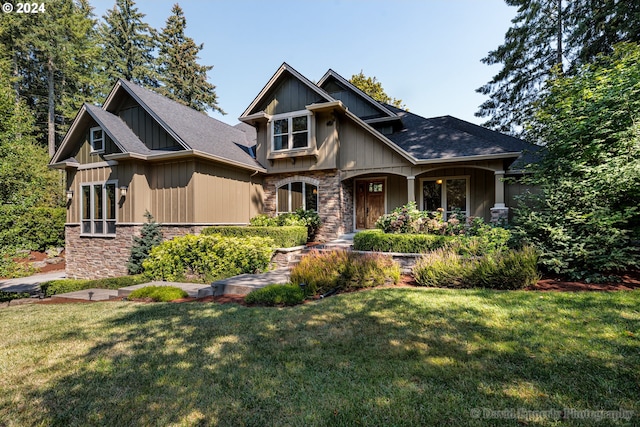 craftsman inspired home with a front lawn