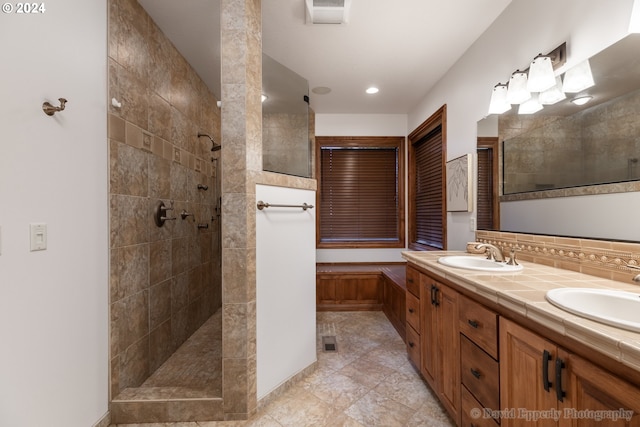 bathroom featuring vanity and tiled shower