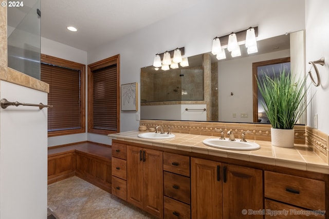 bathroom featuring tile patterned floors, vanity, and a shower