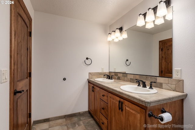 bathroom with vanity and a textured ceiling