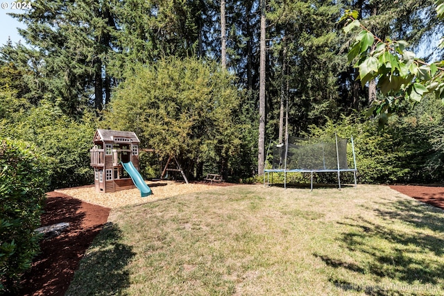 view of yard with a playground and a trampoline