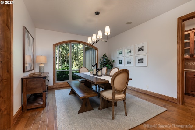 dining space featuring a notable chandelier and hardwood / wood-style floors