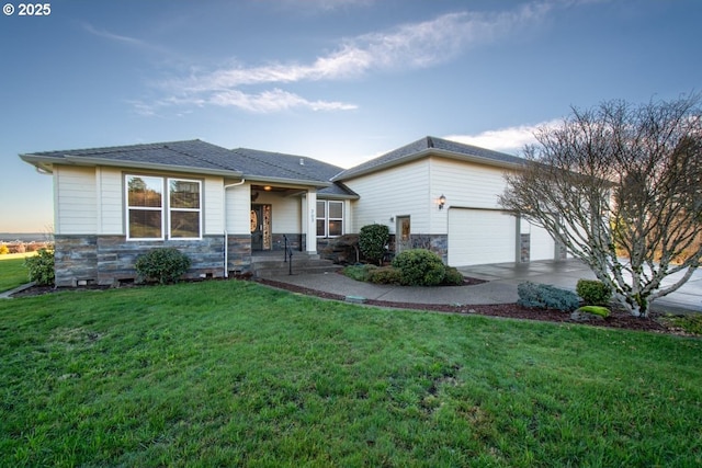 view of front of home with a yard and a garage