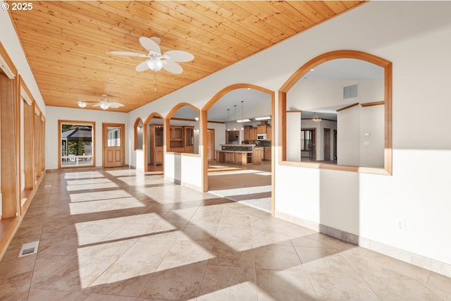 interior space featuring ceiling fan, wood ceiling, and lofted ceiling