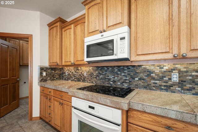 kitchen with white appliances and backsplash