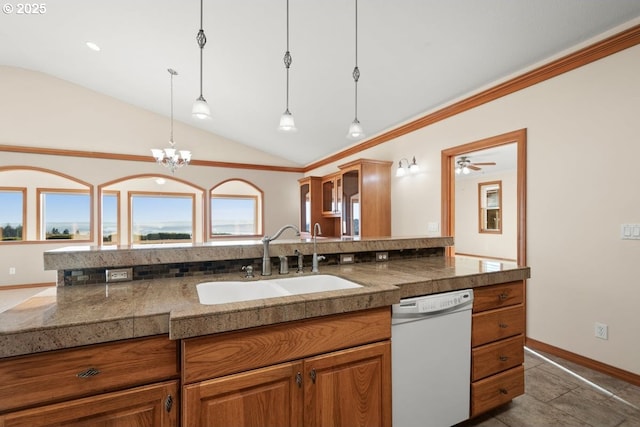 kitchen with white dishwasher, ceiling fan with notable chandelier, sink, hanging light fixtures, and vaulted ceiling