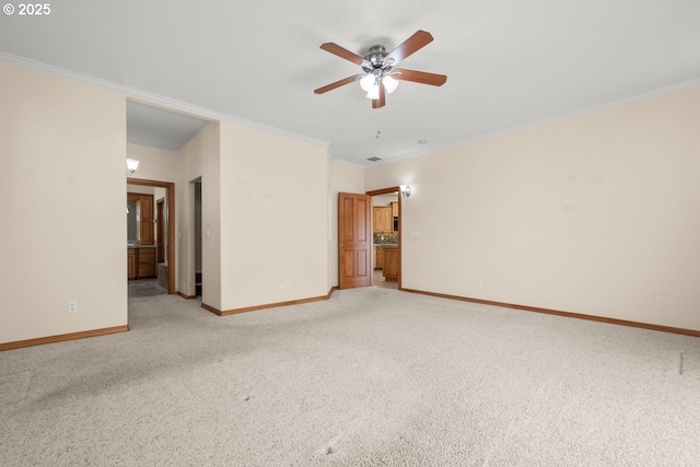 carpeted spare room featuring ceiling fan and ornamental molding