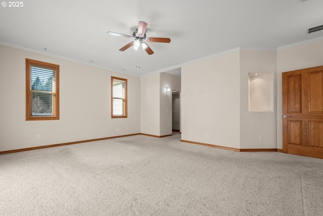 unfurnished room with light colored carpet, ceiling fan, and crown molding