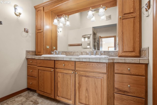 bathroom featuring vanity and tasteful backsplash