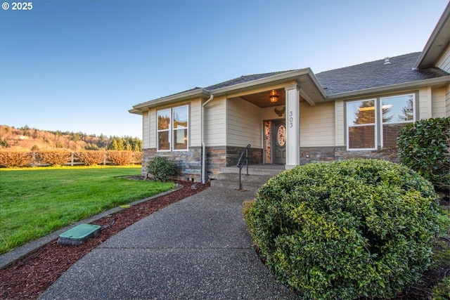 property entrance featuring a lawn