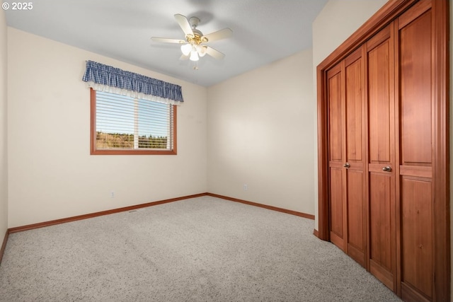 unfurnished bedroom with ceiling fan, a closet, and light colored carpet