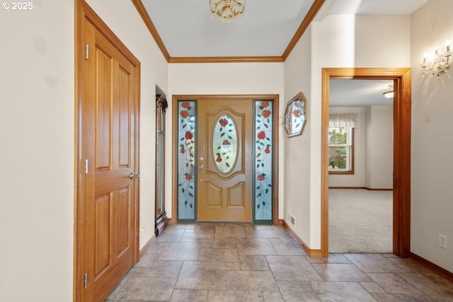 carpeted entrance foyer featuring crown molding